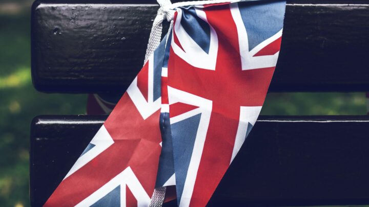 united kingdom flag tied to a wooden bench